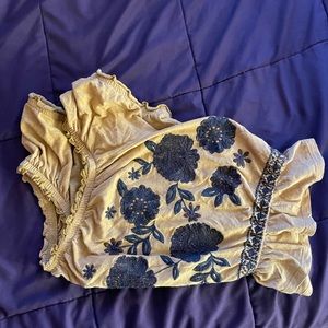 A yellow and floral off the shoulder blouse